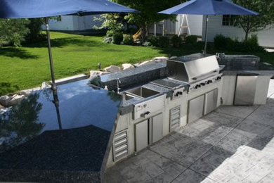 Inspiration for a mid-sized contemporary backyard concrete paver patio kitchen remodel in Salt Lake City with no cover