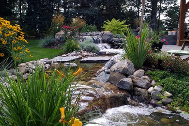 Patio fountain - large traditional backyard stone patio fountain idea in Other with no cover