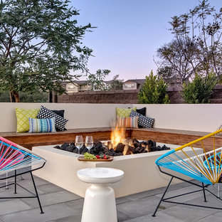 Patio - large contemporary backyard concrete paver patio idea in San Diego with a fire pit