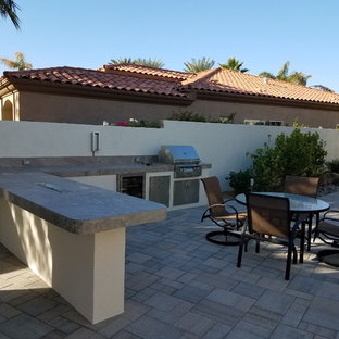 Example of a mid-sized classic backyard patio kitchen design in Other with no cover
