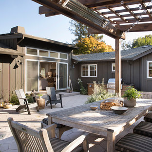 This is an example of a mid-sized transitional backyard patio in San Francisco with a fire feature and a pergola.