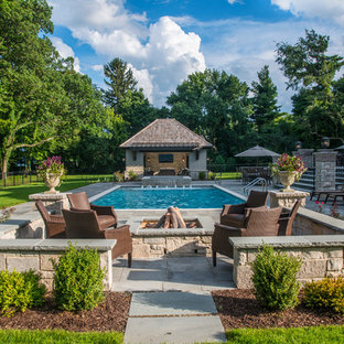 Mid-sized elegant backyard stone patio photo in Chicago
