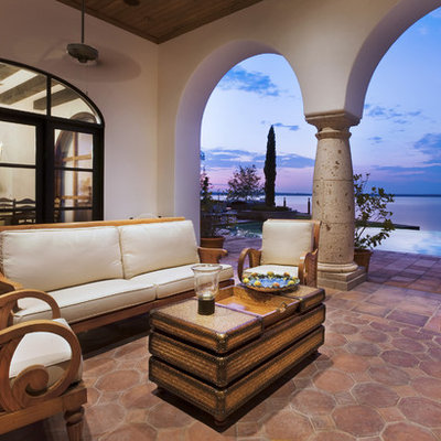 Inspiration for a mediterranean concrete paver patio remodel in Austin with a roof extension