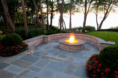 Patio - large coastal stone patio idea in Grand Rapids