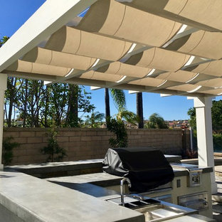 Ispirazione per un patio o portico contemporaneo di medie dimensioni e dietro casa con una pergola