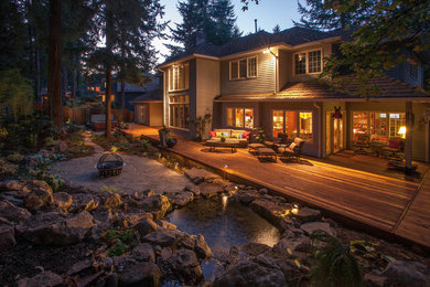 Inspiration for a mid-sized timeless backyard stone patio fountain remodel in Portland with a roof extension