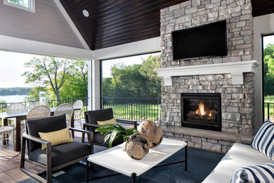 Inspiration for a mid-sized transitional backyard patio remodel in Minneapolis with a fireplace, decking and a roof extension