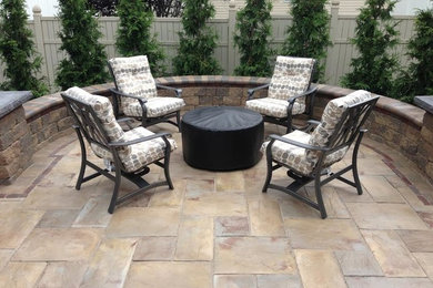 Patio - mid-sized modern backyard stone patio idea in Chicago with a fire pit and no cover