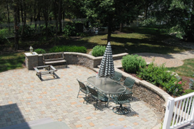 Inspiration for a large backyard patio remodel in New York with a fire pit and an awning