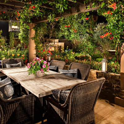 Patio - mediterranean patio idea in Los Angeles with a pergola