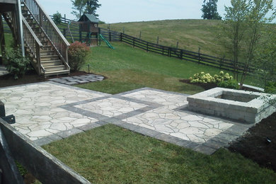 Example of a large trendy backyard concrete paver patio design in Other with a fire pit