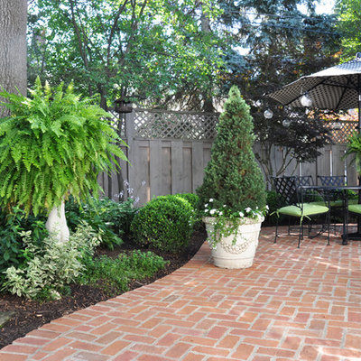 Inspiration for a mid-sized timeless backyard brick patio remodel in Cleveland