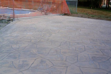 Inspiration for a mid-sized backyard stamped concrete patio remodel in New York with no cover