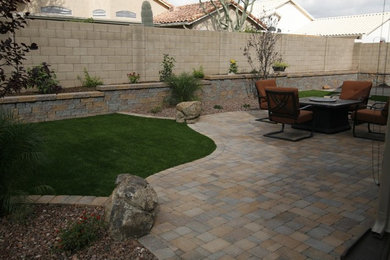 Inspiration for a mid-sized backyard stone patio remodel in Phoenix with no cover