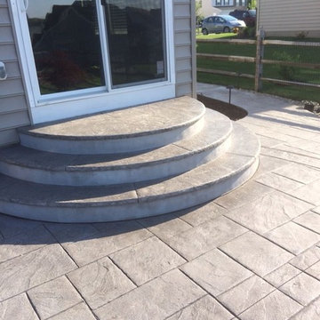 Large ashlar slate stamped patio and bullnose radius steps.