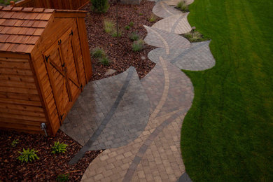 Inspiration for a large backyard concrete paver patio remodel in Edmonton