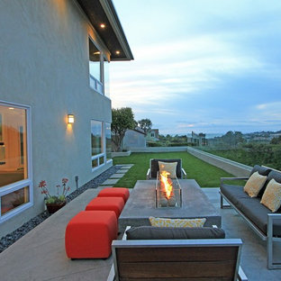 Patio - contemporary backyard patio idea in Orange County with a fire pit