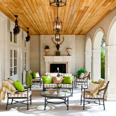 Example of a classic patio design in Dallas with a fire pit