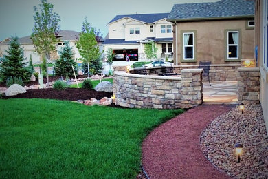Patio - mid-sized rustic front yard stone patio idea in Denver with no cover