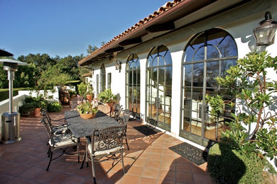 Patio - mediterranean tile patio idea in Santa Barbara with no cover