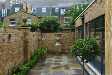 This is an example of a medium sized rustic patio in London.