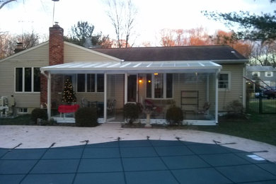 Inspiration for a mid-sized timeless backyard concrete patio remodel in Philadelphia with a pergola