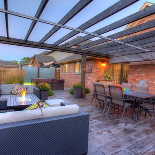 Ispirazione per un grande patio o portico tropicale dietro casa con ghiaia e una pergola