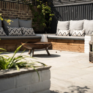 Design ideas for a contemporary back patio in Sussex with concrete slabs and no cover.