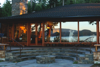 Design ideas for a medium sized world-inspired back patio in Seattle with a fire feature, natural stone paving and no cover.