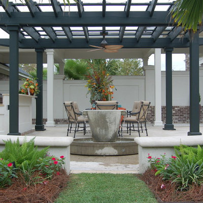 Example of a classic patio kitchen design in Charleston with a pergola