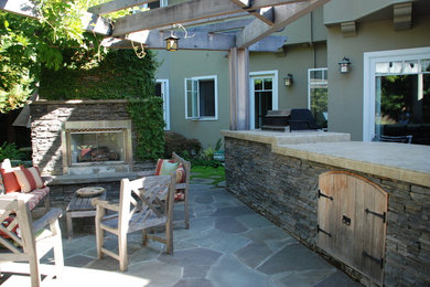 Example of a classic patio design in San Francisco with a fire pit and a pergola
