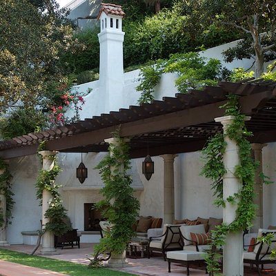 Tuscan patio photo in Los Angeles with a fire pit and a pergola