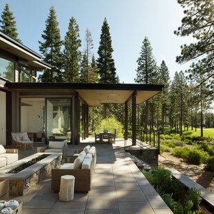 Example of a trendy backyard patio design in Other with a fire pit and no cover