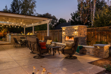 Patio kitchen - large contemporary backyard stamped concrete patio kitchen idea in San Francisco with a pergola