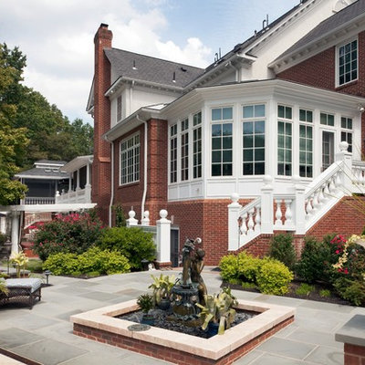Large elegant backyard concrete paver patio photo in New York with no cover
