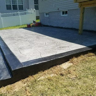 Immagine di un grande patio o portico tradizionale con un focolare, cemento stampato e nessuna copertura