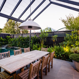 Contemporary backyard patio in Melbourne with a pergola.