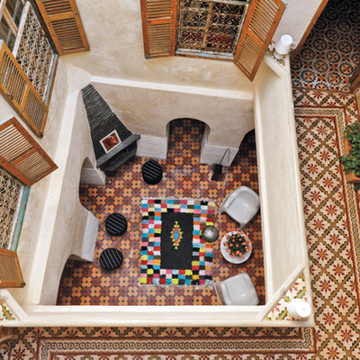 Inspiration for a mediterranean courtyard tile patio remodel in New York with no cover
