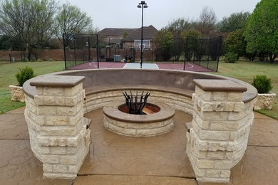 Patio - traditional backyard stamped concrete patio idea in Austin with a fire pit and no cover