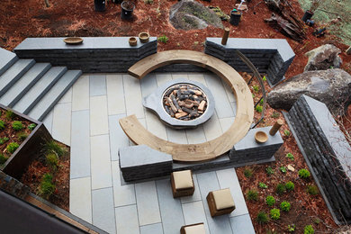 Example of a huge trendy stone patio design in San Francisco with a fire pit and no cover