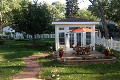 Example of a small trendy backyard stamped concrete patio design in Chicago with a gazebo