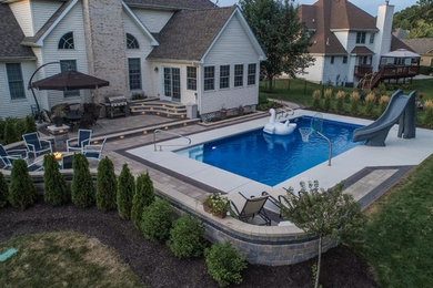 Mid-sized trendy backyard brick patio photo in Chicago with a fire pit