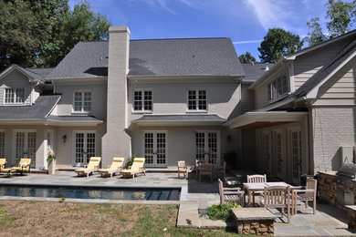 Imagen de patio clásico de tamaño medio en patio trasero y anexo de casas con cocina exterior y adoquines de piedra natural