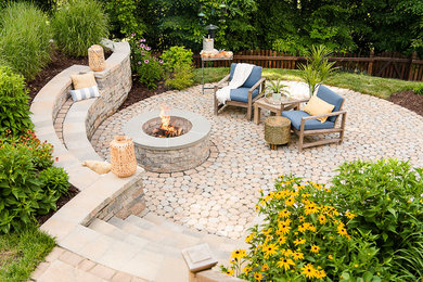 Inspiration for a mid-sized transitional backyard concrete paver patio remodel in Richmond with a fire pit and no cover