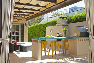 Inspiration for a mediterranean back patio in Los Angeles with a fire feature and a pergola.