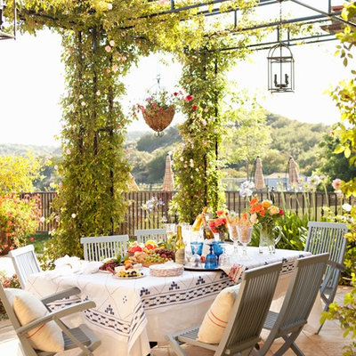 Large tuscan tile patio photo in Los Angeles with a pergola