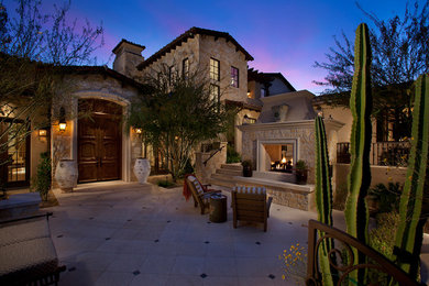 Inspiration for a large mediterranean tile patio remodel in Phoenix with a fire pit and no cover