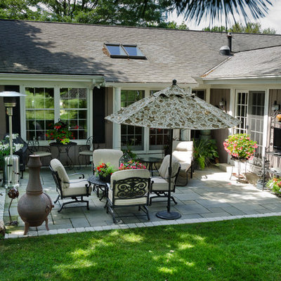Inspiration for a mid-sized transitional backyard stone patio remodel in Milwaukee