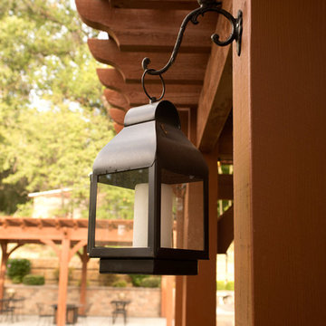 Metal Candle Lantern hung from Timber Frame Pergola