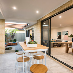 Inspiration for a contemporary backyard patio in Perth with tile and a roof extension.